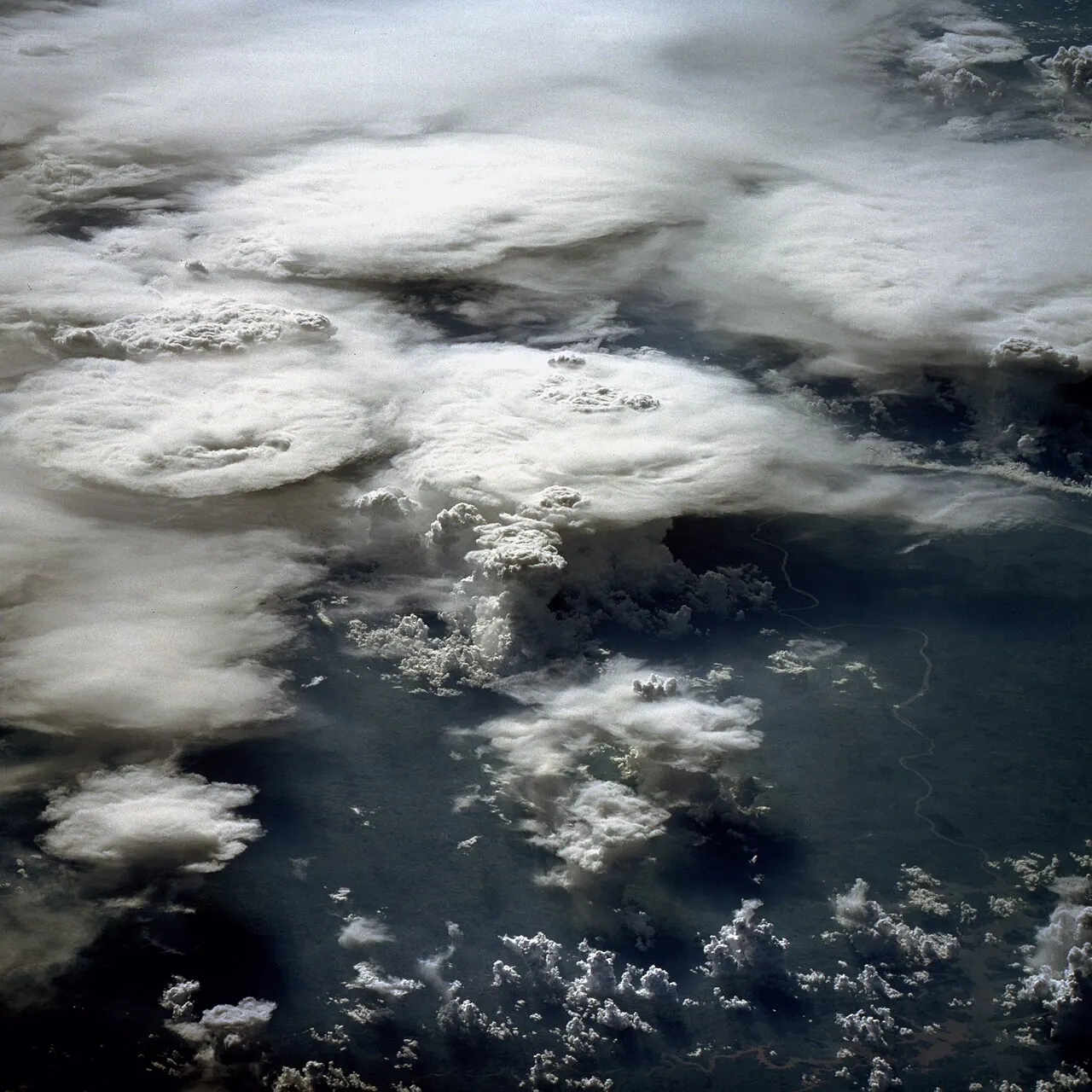 Towering cumulonimbus thunderstorm clouds photographed from the Space Shuttle above Brazil.