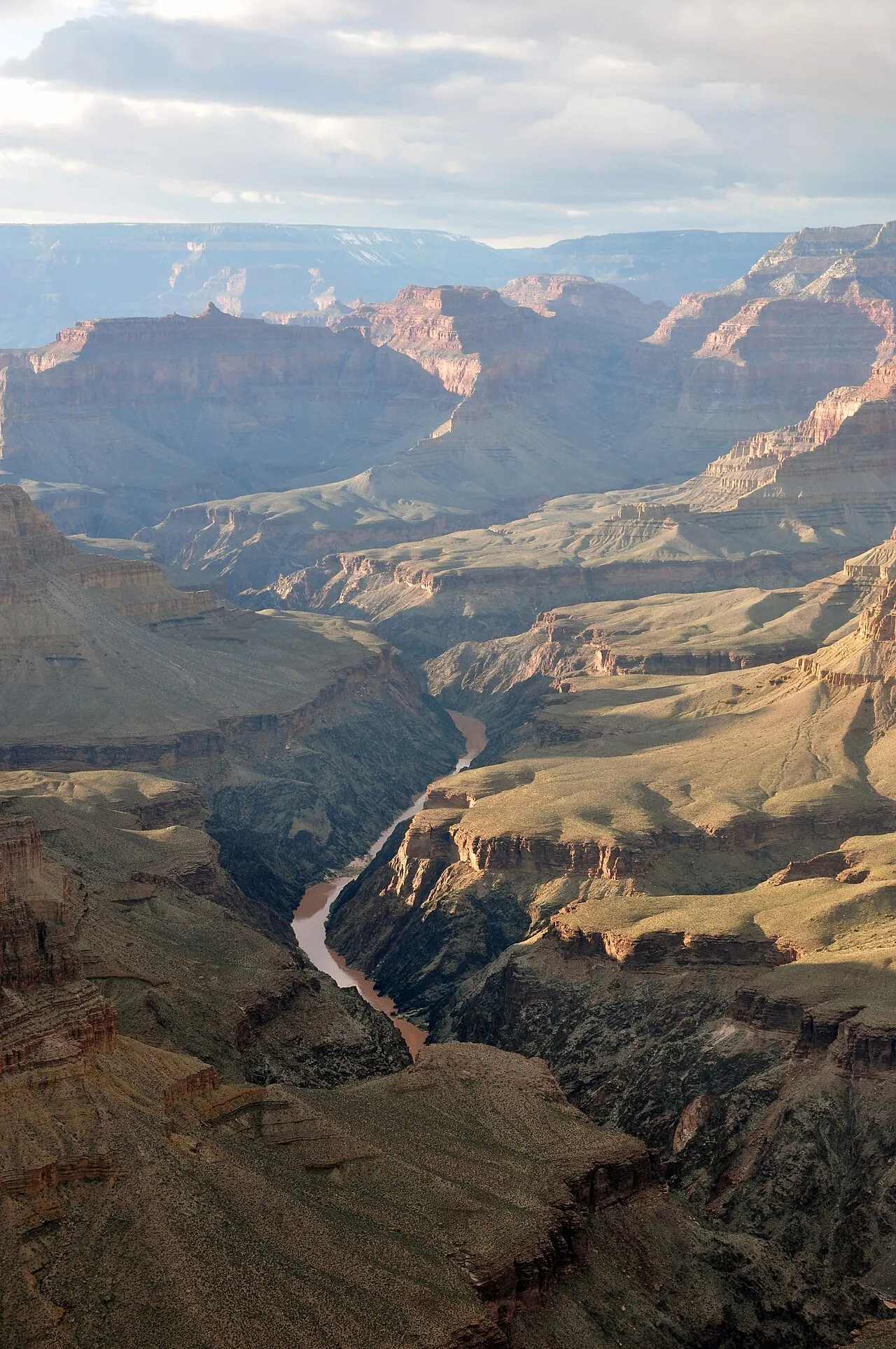 The Grand Canyon from Pima Point, with the Colorado River far below and hundreds of horizontal rock layers exposed in the canyon walls.