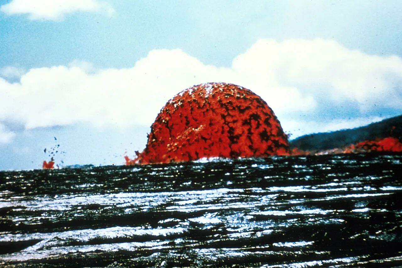 A tall fountain of glowing orange lava jetting from a volcanic vent at Kilauea, Hawaii.
